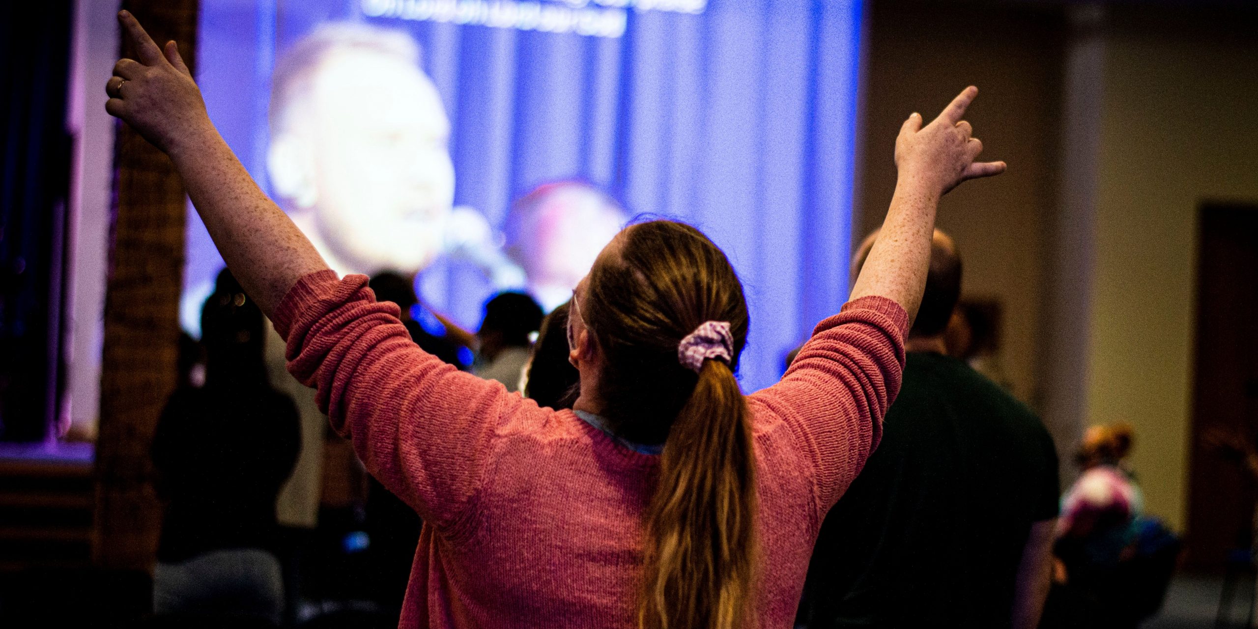 Lady with hands raised in praise to God