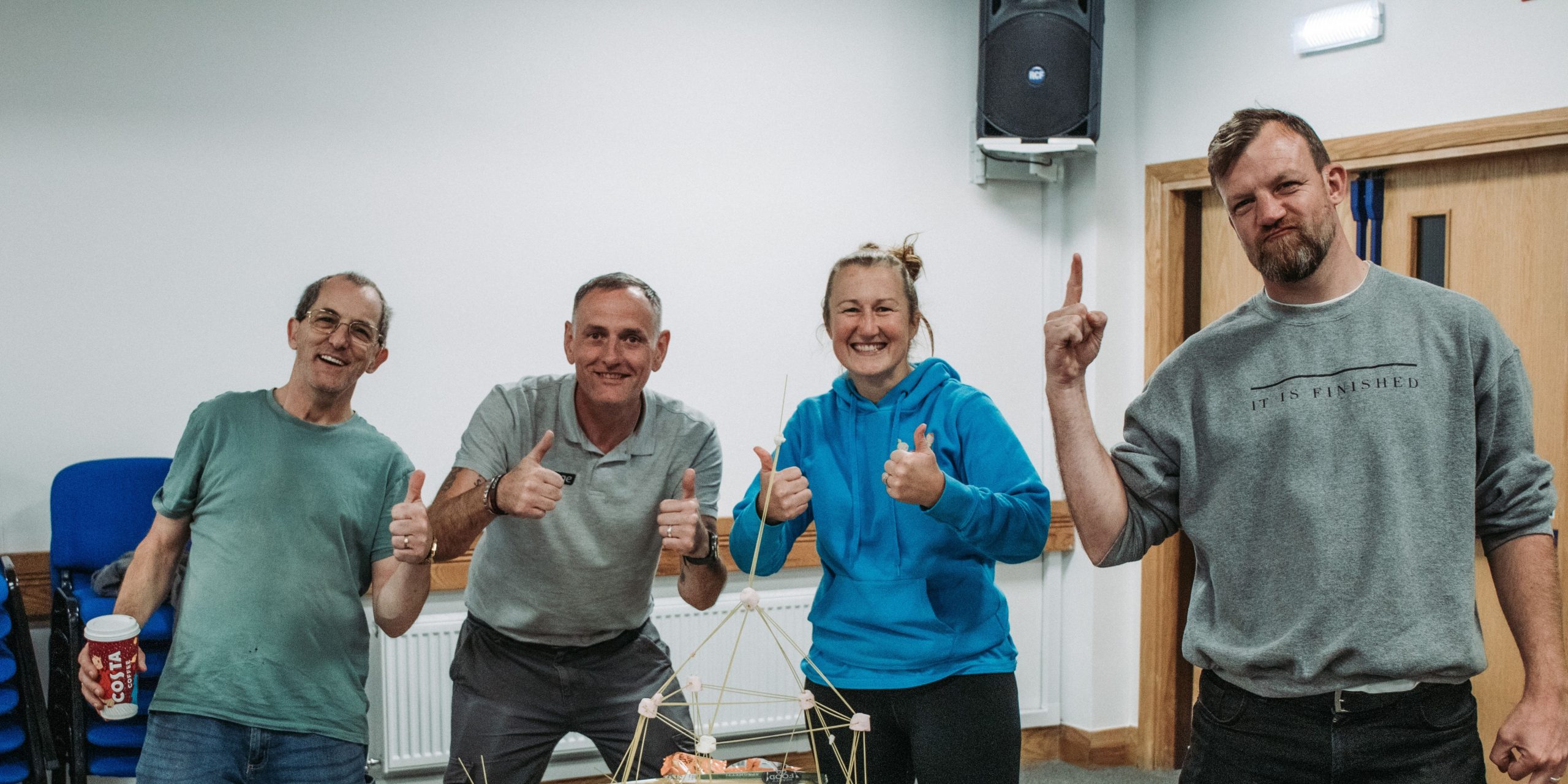 Four team members looking joyful.