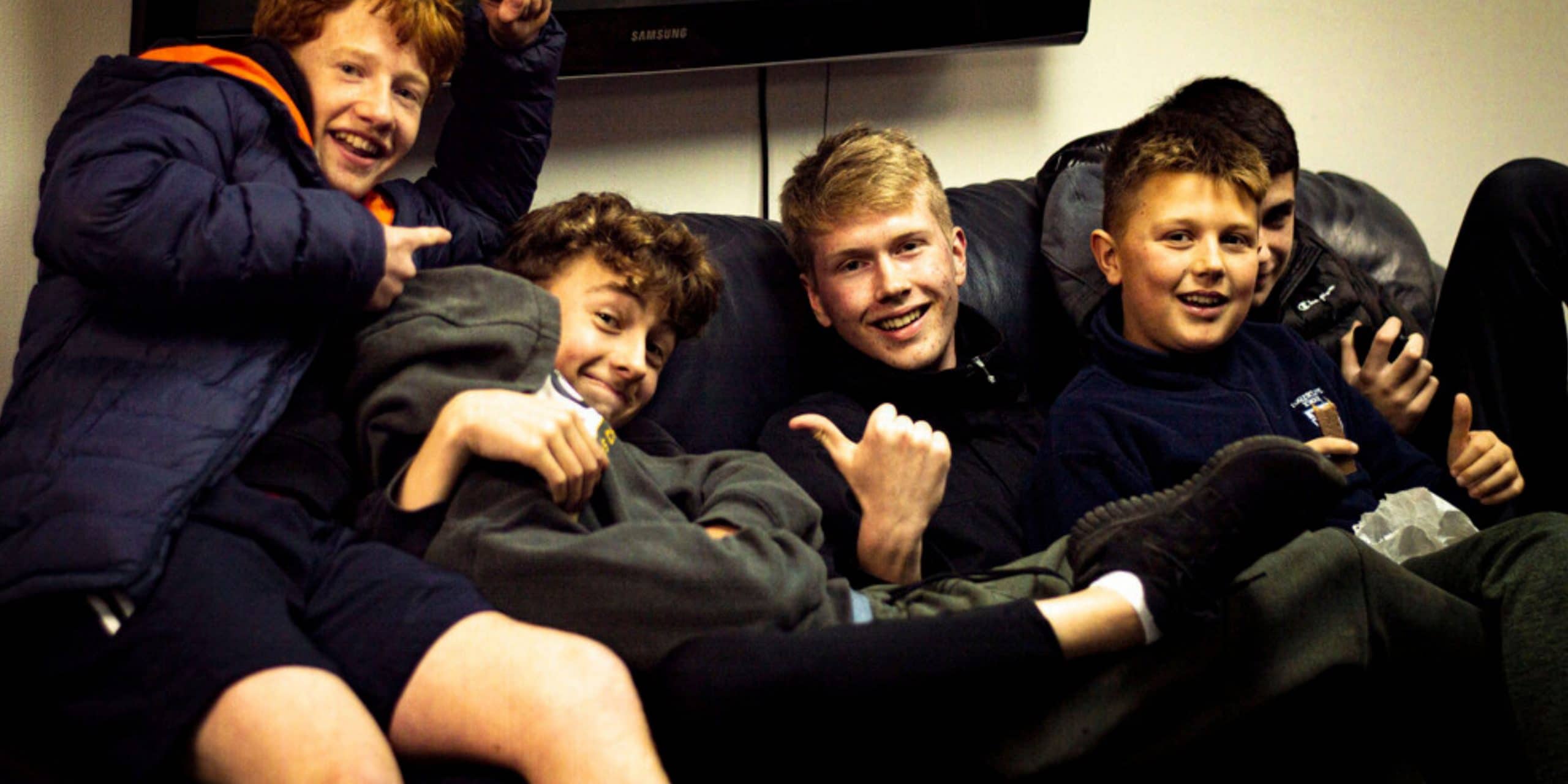 a group of teens on a sofa