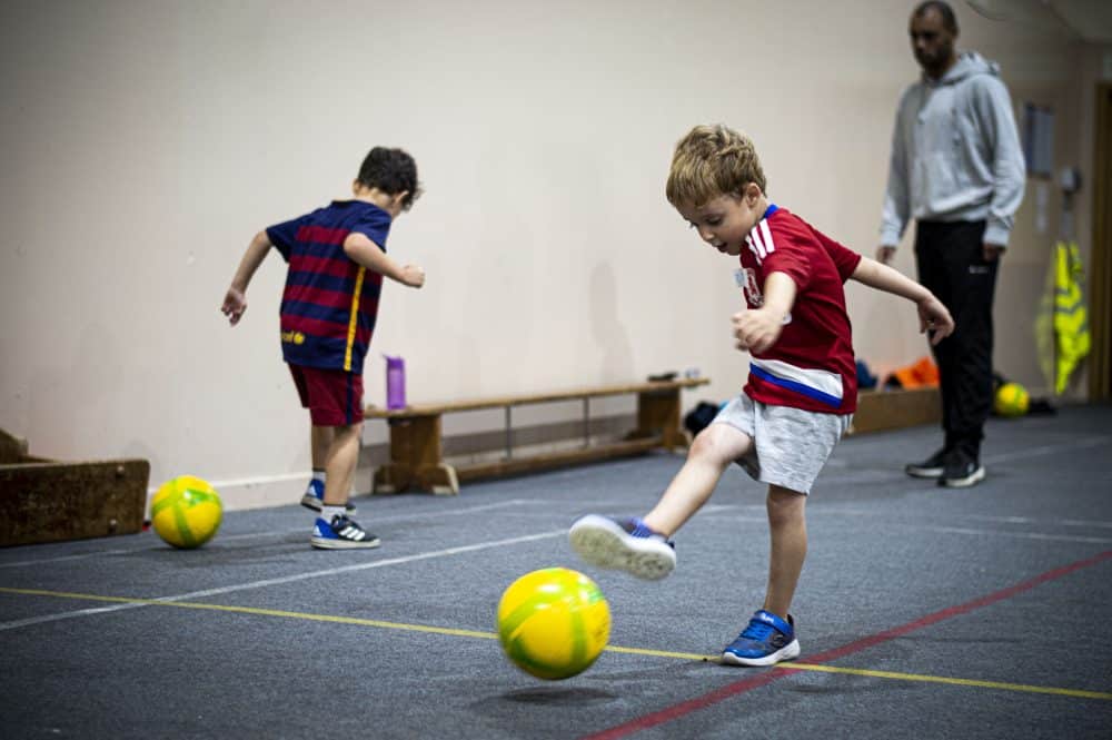 boy kicking football