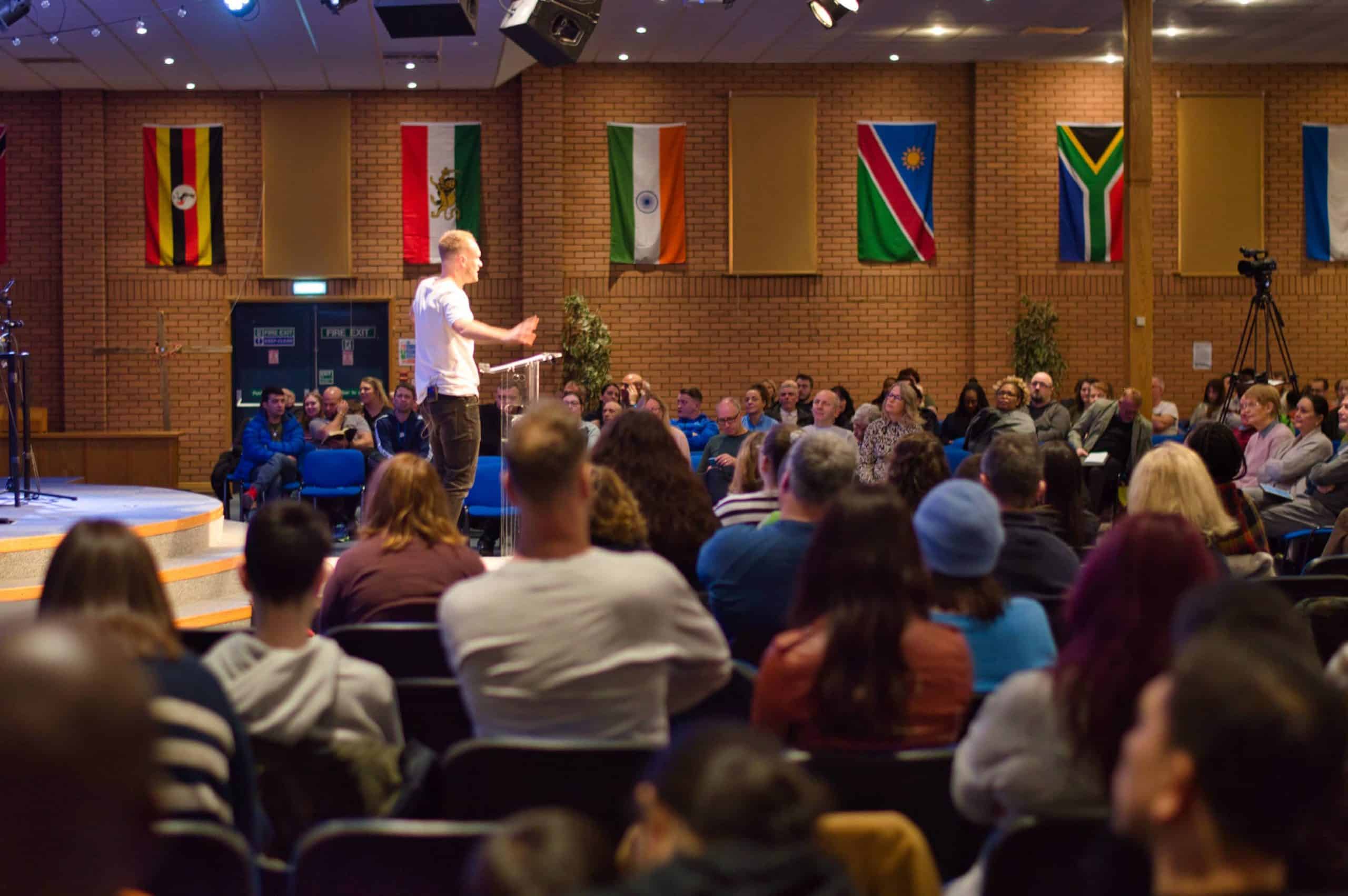 a man speaking to a large audience