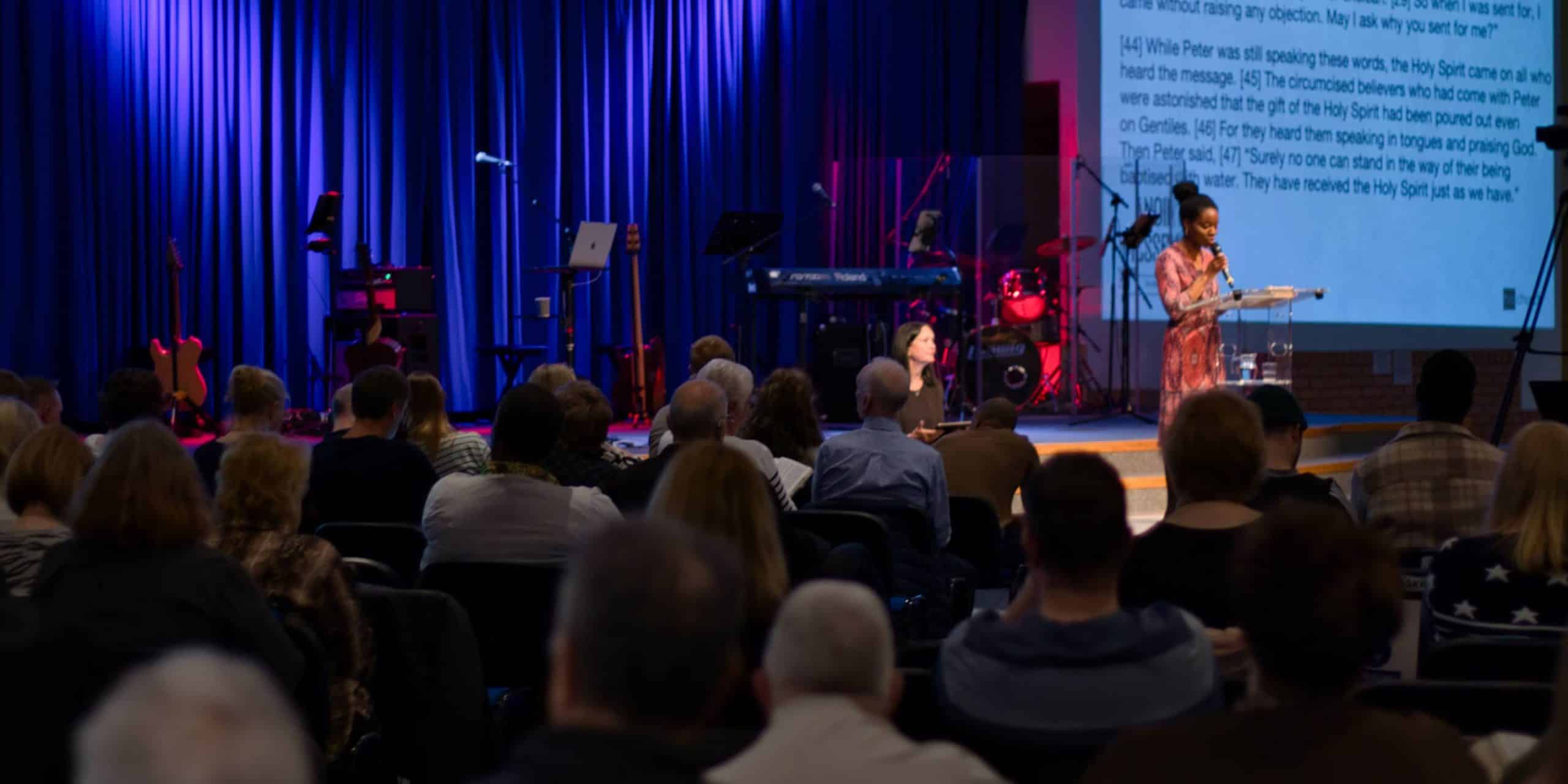 a person reading a bible scripture to the congregation