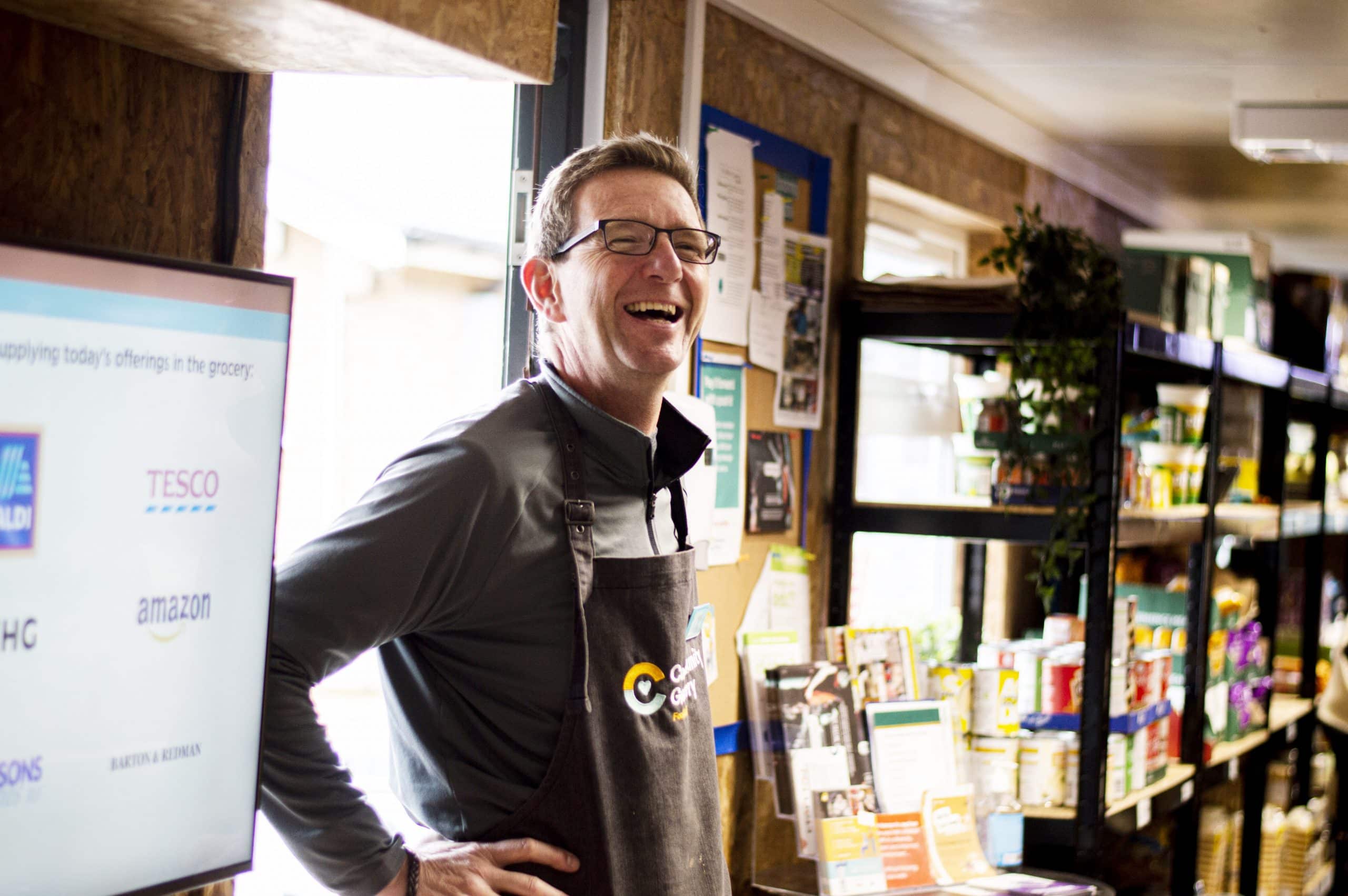 Community Grocery Manager Andy Malbon at Ragworth Community Grocery, he is smiling