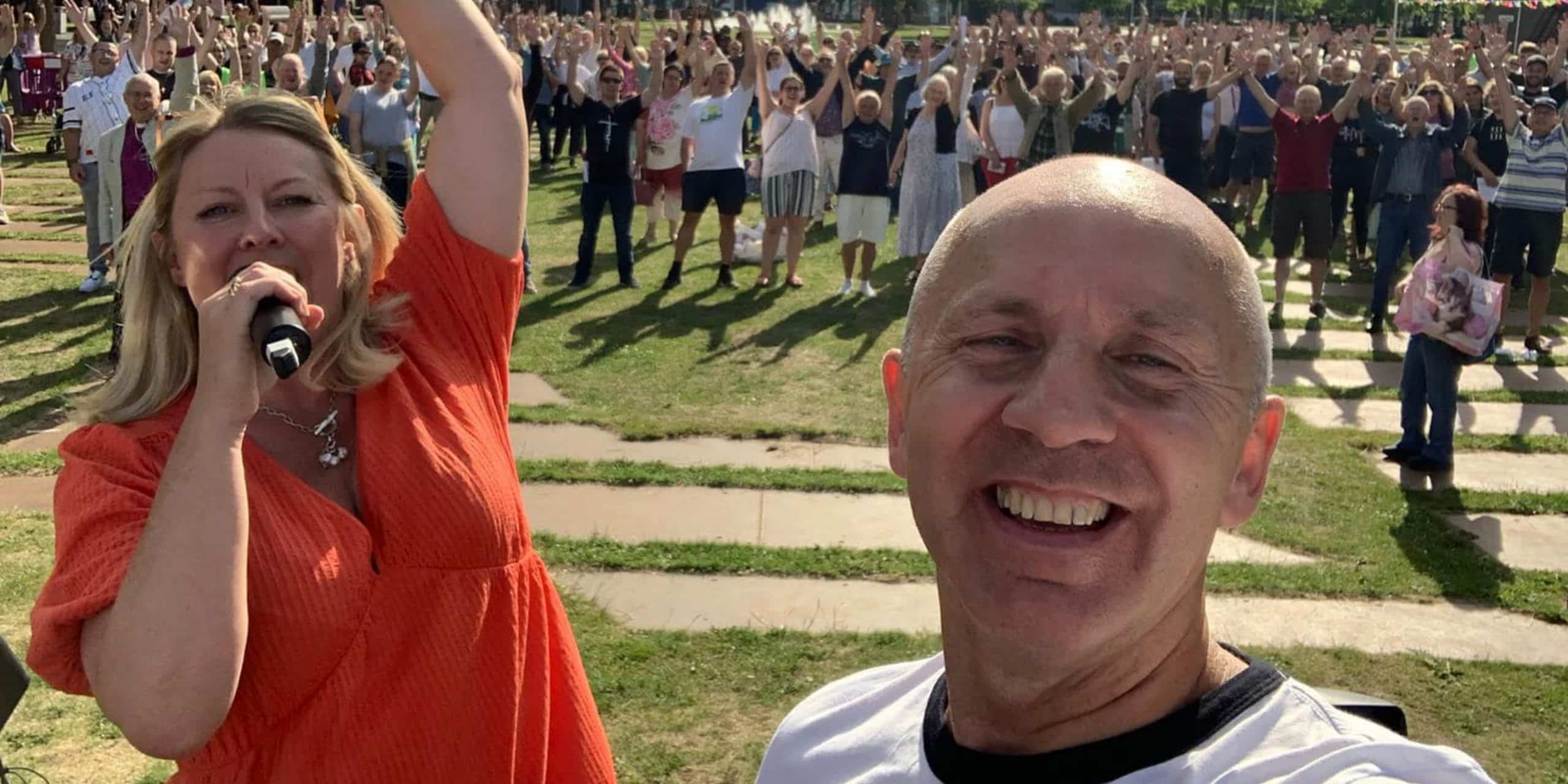 Leaders on stage at a Festival Teesside prayer event at Middlesbrough Centre Square, taking a selfie of themselves and the large crowd behind them